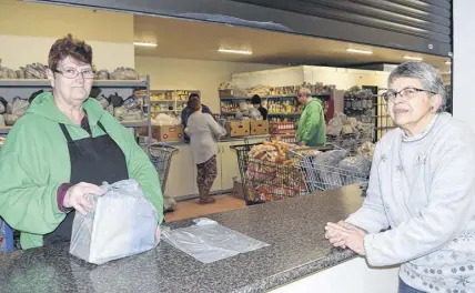  ?? HARRY SULLIVAN/TRURO NEWS ?? Colchester Food Bank volunteer Debbie Scott, left, and board secretary Vera Smith are seen getting set to greet another group of clients at their new facility on Prince Street.