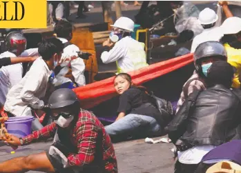  ?? STRINGER / REUTERS ?? Angel, a 19-year-old protester also known as Kyal Sin, lies on the ground before she was shot and killed after Myanmar's forces opened fire to disperse an anti-coup demonstrat­ion in Mandalay on Wednesday.