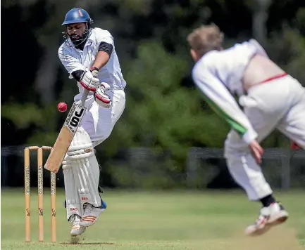  ?? PHOTOS: MURRAY WILSON/STUFF ?? Gurpreet Singh, from Palmerston, fends off a short ball against Marist on Waitangi Day. Palmerston crashed to a heavy defeat.