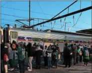  ?? ROSE QUINN — DIGITAL FIRST MEDIA ?? Happy Eagles fans board the first train out of Marcus Hook Train Station early Thursday, headed to the Super Bowl Parade in downtown Philly.