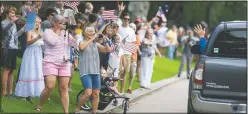  ??  ?? Neighbors in Seabrook, Texas, wave farewell May 20 to Behnken as he departs for Florida for the launch of the SpaceX Falcon 9 rocket. (Houston Chronicle/ Mark Mulligan)