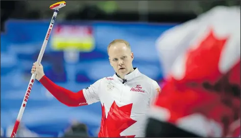  ?? RICHARD GRAY, WORLD CURLING FEDERATION/THE CANADIAN PRESS, HO ?? Canada third Mark Nichols reacts as he watches his shot during his team’s extra-end victory over South Korea on Tuesday.