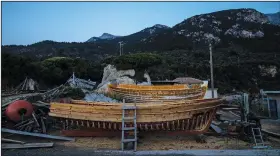 ??  ?? Wooden boats stand June 9 at Agios Isidoros boatyard.