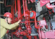  ?? JIA CHENGLONG / FOR CHINA DAILY ?? A technician checks a facility of Shenhua Group in Tianjin Port.