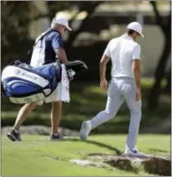  ?? ERIC GAY — THE ASSOCIATED PRESS ?? Defending champion Jason Day, right, walks toward the seventh hole after he conceded to Pat Perez during roundrobin play at the Dell Technologi­es Match Play tournament at Austin County Club Wednesday.