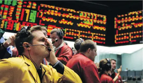  ?? THE ASSOCIATED PRESS ?? Clerk Michael Hill puts his hand on his face in the Euro Dollar options trading pit as stock markets shuddered and then collapsed in a cascading panic during the financial crisis of 2008.