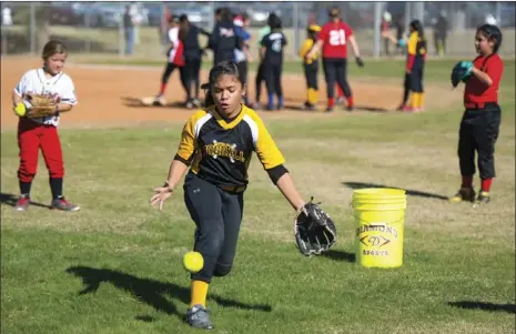  ??  ?? Alexandra Gutierrez, 10, attempts to catch a ball during Imperial Valley College’s second annual all-skills softball camp held Thursday morning at IVC in Imperial. VINCENT OSUNA PHOTOS