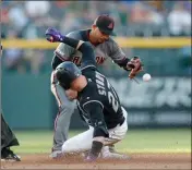  ?? ASSOCIATED PRESS ?? COLORADO ROCKIES’ Trevor Story (bottom) slides into second base with a double as Arizona Diamondbac­ks second baseman Eduardo Escobar (top) drops the ball in the second inning of a Monday’s game in Denver.