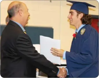  ?? Photograph­s by Cary Beavers ?? Graduating senior Zachary Bergman accepts his diploma from Council Rock School Board member Jerold Grupp June 19.