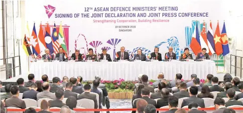  ?? — AFP photo ?? Asean defence ministers hold signing ceremony of 12TH ADMM Joint Declaratio­n at the Asean security summit in Singapore.