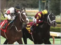  ?? The Sentinel-Record/RICHARD RASMUSSEN ?? Jockey John Velazquez and Coal Front (right) beat Copper Bullet (1) to win the Razorback Handicap at Oaklawn Park on Monday. Coal Front’s winning time was 1:43.45 in the 1 1/16-mile race.