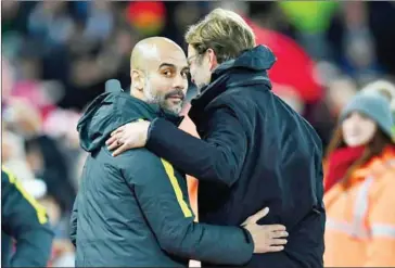  ?? PAUL ELLIS/AFP ?? Liverpool manager Jurgen Klopp (right) greets Manchester City coach Pep Guardiola ahead of their English Premier League football match at Anfield on December 31, 2016.