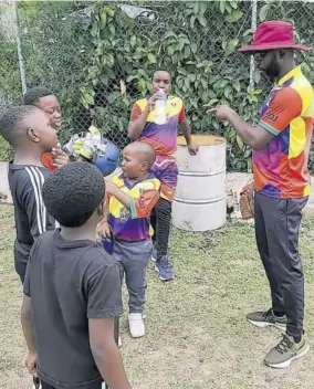  ?? ?? Former West Indies and Jamaica cricketer Nikita Miller (right) speaks to young aspirants during the 2022 4Milla Academy Summer Camp at Melbourne Cricket Club.