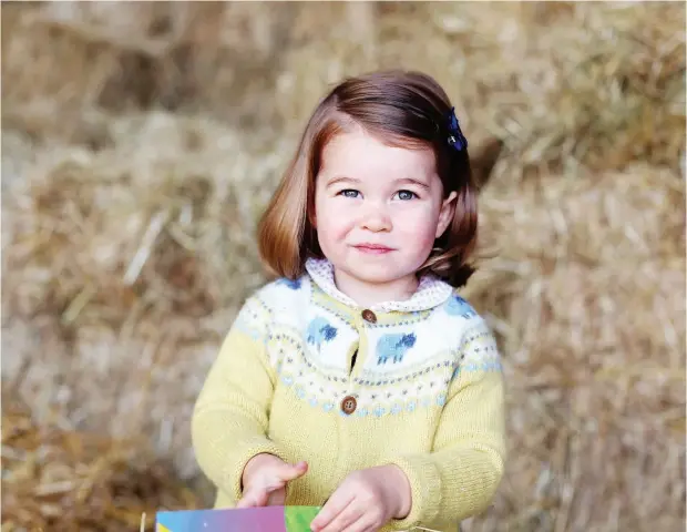  ?? AGENCE FRANCE- PRESSE PHOTO / KENSINGTON PALACE / THE DUCHESS OF CAMBRIDGE ?? A picture released by Kensington Palace and Britain’s Duke and Duchess of Cambridge shows Princess Charlotte of Cambridge at Anmer Hall in the village of Anmer in Norfolk, eastern England, in April, in advance of her second birthday on Tuesday. The...