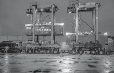  ?? ANDREW TESTA/THE NEW YORK TIMES ?? Shipping containers filled with thousands of bottles of wine are loaded onto a freight train Saturday at Tilbury Docks in London. As Britain continues to face problems in its supply chain, distributo­rs and retailers are looking for creative fixes.