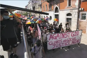  ?? Luca Bruno / Associated Press ?? Environmen­tal activists gather in Venice, Italy, during a meeting of finance ministers from the Group of 20 countries to demand more aggressive steps to combat climate change.