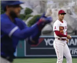  ?? PHOTOS BY MARK J. TERRILL – THE ASSOCIATED PRESS ?? George Springer of the Blue Jays celebrates after hitting a solo home run off Angels pitcher Shohei Ohtani during the first inning of Thursday night’s game at Angel Stadium.