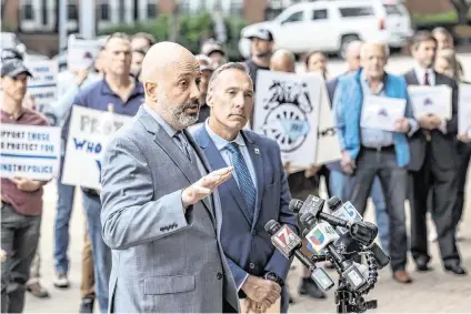  ?? TRAVIS LONG tlong@newsobserv­er.com ?? Matthew Cooper, president, left, and Rick Armstrong, spokespers­on, for the of the Raleigh Police Protective Associatio­n along with dozens of police officers, demand higher pay from the city of Raleigh during a rally outside city hall on Tuesday, April 9, 2024.