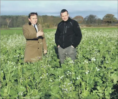  ?? PICTURE: GARY LONGBOTTOM. ?? FIELDWORK: Farming Minister George Eustice, left, with farmer Richard Bramley at Manor Farm, Kelfield near Cawood.