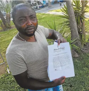  ??  ?? Asylum seeker Ebenezer with his prison release papers, in Catania, Sicily.