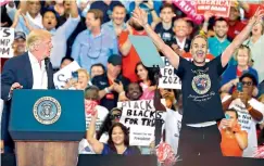  ??  ?? President Donald Trump brings a member of the audience to speak during his rally in Melbourne, Florida. Mr Trump had seen Gene Huber on television as he queued to get into the rally. Huber said he salutes a cardboard cut-out of the President every day....