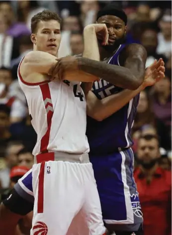  ?? RICK MADONIK/TORONTO STAR ?? Raptors rookie Jakob Poeltl tangles with Kings centre DeMarcus Cousins in the second half of Sunday’s game.