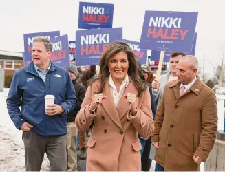  ?? Joe Raedle/TNS ?? Republican presidenti­al candidate, former U.N. Ambassador Nikki Haley is joined by New Hampshire Gov. Chris Sununu as they visit a polling location at Winnacunne­t High School to greet voters on Tuesday in Hampton, New Hampshire.
