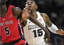  ?? File photo ?? Providence’s Emmitt Holt (15) and Texas’ Andrew Jones have battled back from health problems to return to the court this season. The Friars and Longhorns meet Saturday.