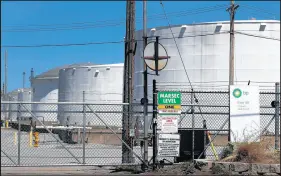  ?? CHARLES REX ARBOGAST/AP ?? Petroleum storage tanks at the BP Indiana Tank Field stand behind a security gate April 21 in Whiting. BP’s profits have plunged during the COVID-19 pandemic as a result of falling demand for oil and gas.