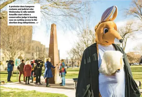  ?? AP ?? A protester dons kangaroo costume and judicial robe Wednesday in rally outside Amarillo court where a conservati­ve judge is hearing case on curbing access to the abortion drug mifepristo­ne.