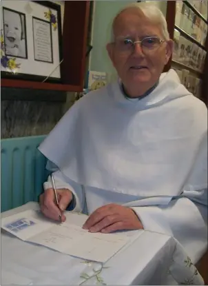  ??  ?? The very popular Fr Chris signing Mass Cards at the Dominican.