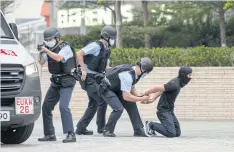  ?? ?? Armed police officers arrest an actor posing as a terrorist during a counterter­rorism exercise organised by the Hong Kong Police Force at West Kowloon Station on Nov 19.