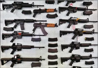  ?? AP Photo/Brennan Linsley, File ?? Guns: In this July 20, 2014 file photo, guns are displayed for sale by an arms seller east of Colorado Springs, Colo. The U.S. is among wealthy countries where suicides by gun outnumber gun killings, according to a study of 1990-2016 data, released on Tuesday.