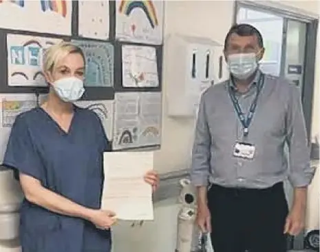  ??  ?? Senior nurse Nicola Peat receives an Excellence Reporting letter by Ken Bremner, South Tyneside and Sunderland NHS Foundation Trust’s chief exec.