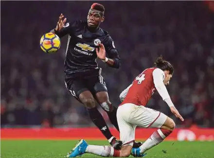  ??  ?? Manchester United’s Paul Pogba steps on Arsenal’s Hector Bellerin and was subsequent­ly shown a red card by referee Andre Marriner on Saturday.