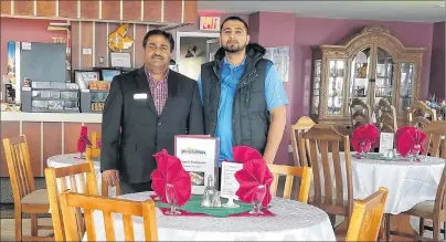  ?? SUBMITTED PHOTO ?? Maqbool (Mack) Bhatti, left, and his son, Ali Bhatti, pose for a photo in the new restaurant that opened at the Trailsman Motel in Nyanza, Victoria County, on Sunday. The Bhattis have spent approximat­ely $500,000 in renovation­s on the motel.