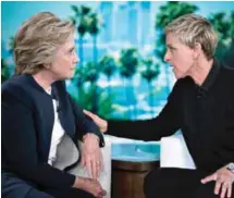  ?? — AFP ?? BURBANK, California: Democratic presidenti­al nominee Hillary Clinton (left ) and TV host Ellen DeGeneres talk during a commercial break of the taping of the Ellen Show on Thursday.