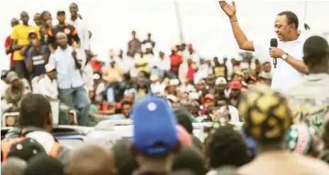  ?? Kenya’s President Uhuru Kenyatta (right) addresses a crowd yesterday, in a Nairobi susburb, following an announceme­nt by the country’s Supreme Court that Kenya’s August 8 election, in which Uhuru was declared winner, had been cancelled AFP ??