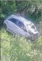  ?? HT PHOTO ?? The car that skidded off a road and plunged into a deep gorge at Kandu on PathankotC­hamba national highway.