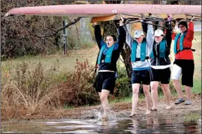  ?? Democrat-Gazette file photo ?? Recent research at Oxford University found that rowers’ pain tolerance improves when they work out in a group. That principle doesn’t appear to apply in this photo from November 2006, as Shannon Goforth (left) winces while stepping into water as her...