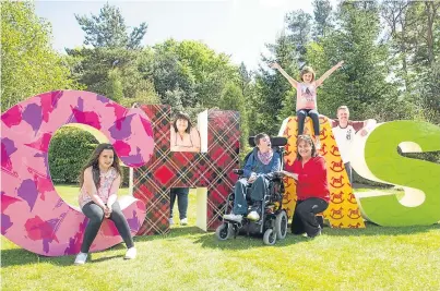  ?? Picture: Angus Findlay. ?? Maria McGill, centre, with the Scott family, who helped design the new alphabet, from left, Lilly, 10, Adam, 16, mum Lynne, Aime, 7, and stepdad Gavin.