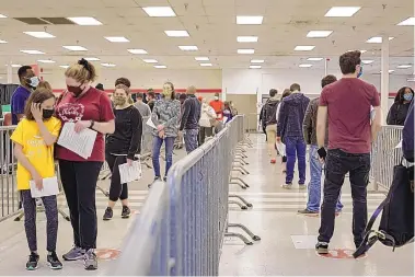  ?? CARLOS BERNATE/BLOOMBERG ?? Residents wait in line to be vaccinated April 10 at the Lynchburg Regional Vaccinatio­n Center in Lynchburg, Va.