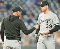  ?? CHARLIE RIEDEL/AP ?? White Sox manager Pedro Grifol talks with relief pitcher Aaron Bummer after making a pitching change during the sixth inning against the Kansas City Royals on Monday.