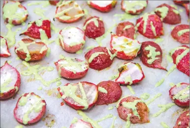 ?? Associated Press photo ?? This photo shows roasted radishes with green goddess dressing, in Bethesda, Md. The recipe tops plain roasted radishes with a quick green goddess dressing made from Greek yogurt, lemon juice, dill and parsley.