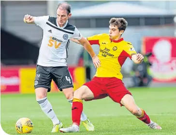  ??  ?? Partick Thistle’s Cammy Palmer challenges veteran Ayr United midfielder Mark Kerr