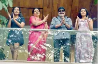  ??  ?? Actor Rajasekhar with his wife Jeevita and their daughters clap from the residence balcony on Sunday.