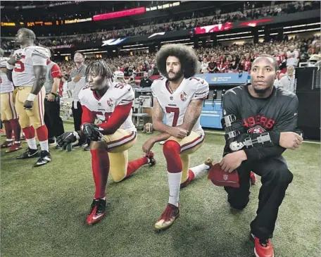  ?? John Bazemore Associated Press ?? PROTESTS BY NFL players, especially ex-49er Colin Kaepernick, center, were called un-American — and worse — by President Trump.