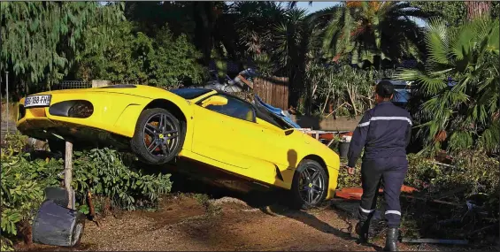  ??  ?? A Ferrari swept along by a torrent of mud and floodwater in the town of Biot. Up to seven inches of rain fell in the region in just three hours