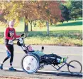  ?? COURTESY PHOTO ?? Kevin Toomey, of Bristol, pushes Greg Selavka, of Manchester, in a local road race.