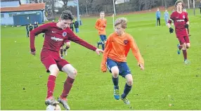  ??  ?? Before the Christmas break, Dryburgh U/15s (maroon) edged past Fairmuir with a penalty shootout seeing them into the Tommy Clark Trophy semi-finals.